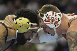 Oklahoma State's Wyatt Hendrickson, right, takes on Minnesota's Gable Steveson during the 285-pound championship match at the NCAA wrestling championship in Philadelphia. (AP Photo/Matt Rourke)