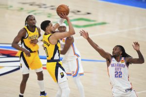 Indiana Pacers guard Tyrese Haliburton shoots over Oklahoma City Thunder guard Cason Wallace during the second half of Game 1 of the NBA Finals in Oklahoma City. (AP Photo/Julio Cortez)