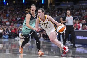 Indiana Fever guard Caitlin Clark drives on New York Liberty guard Sabrina Ionescu in the second half of a game in Indianapolis. (AP Photo/Michael Conroy)